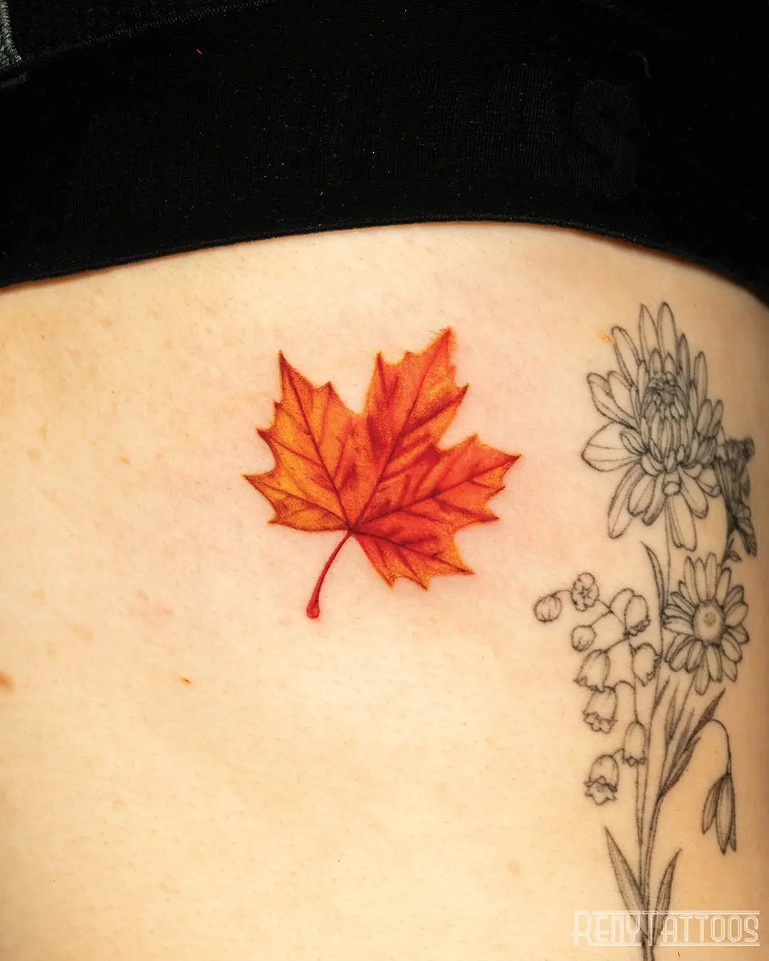 Vibrant maple leaf tattoo showcasing autumn hues