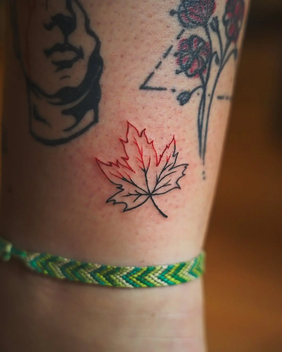Elegant red maple leaf tattoo design