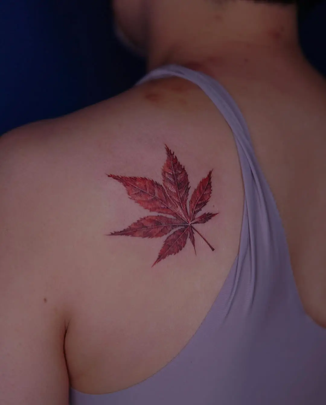Stunning red maple leaf tattoo on back
