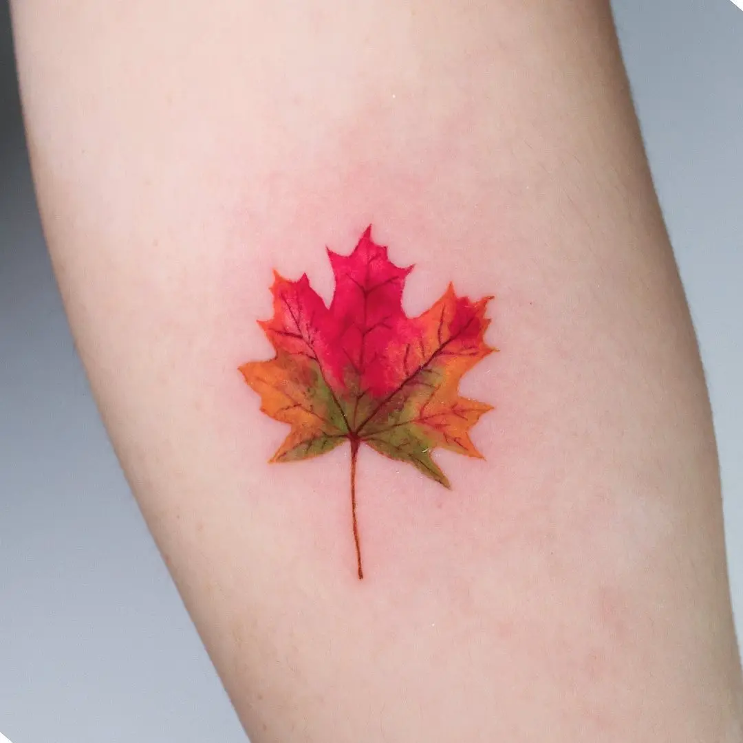 Vibrant maple leaf tattoo showcasing autumn hues
