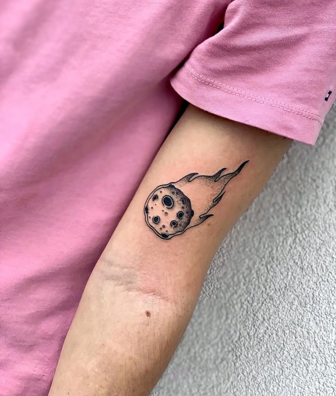 Dynamic meteor tattoo with striking flame details
