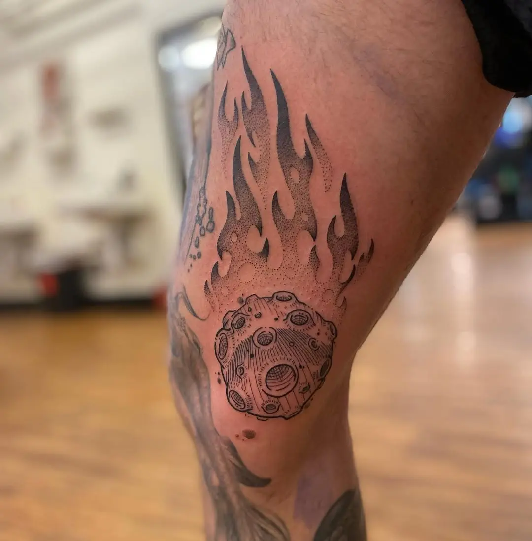 Dynamic meteor tattoo surrounded by fiery flames