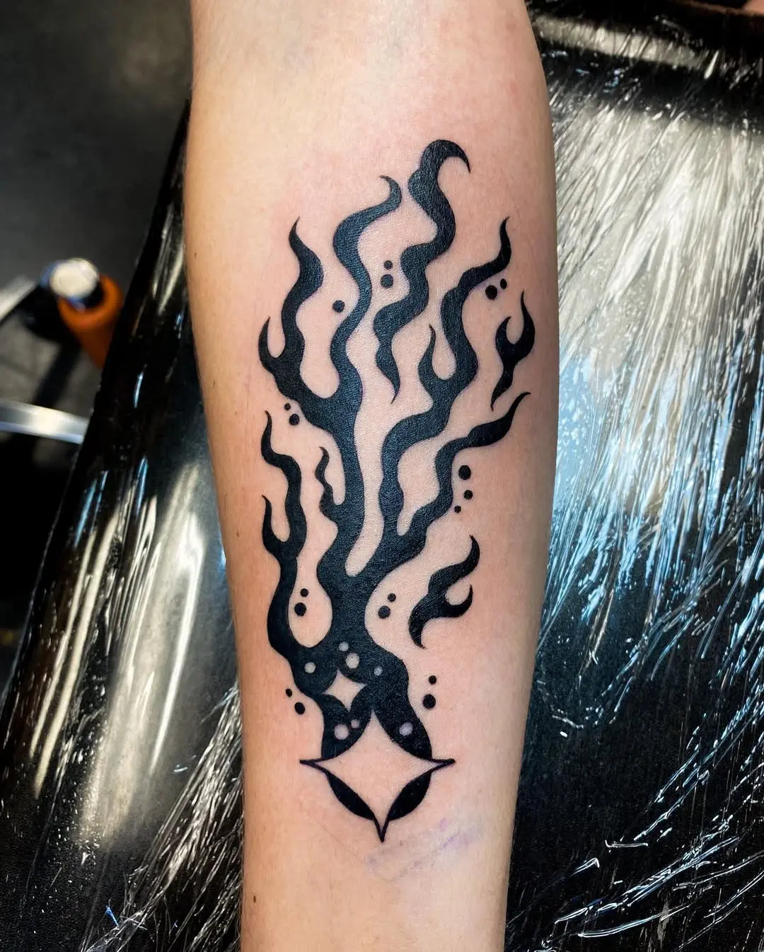 Striking black ink flame-style meteor tattoo