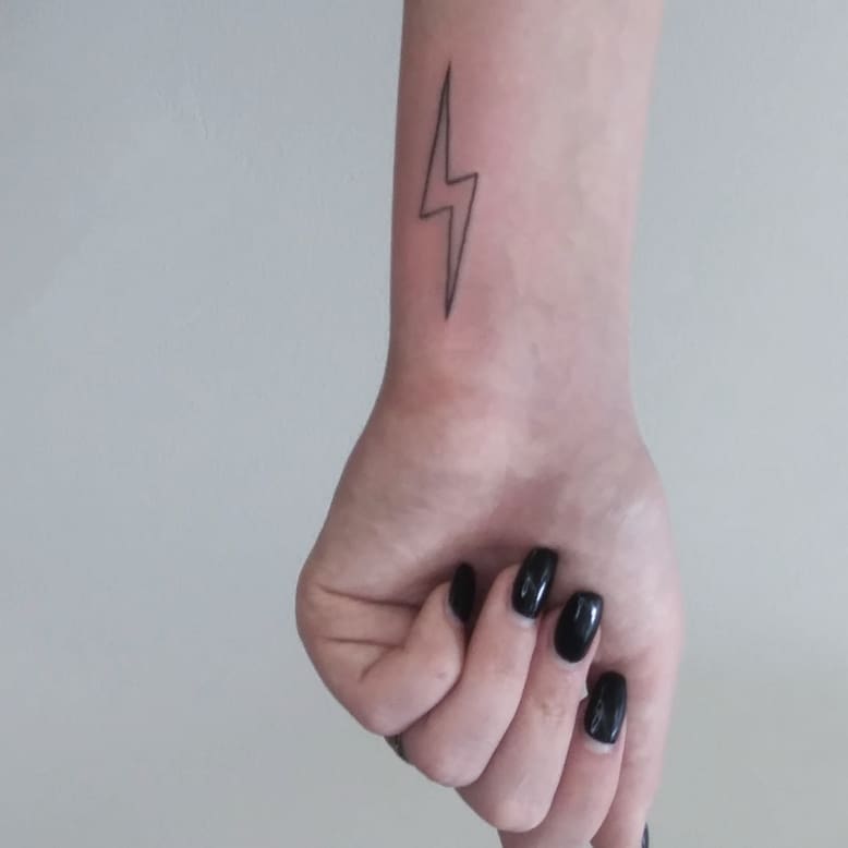 Elegant minimalism in lightning bolt tattoo design
