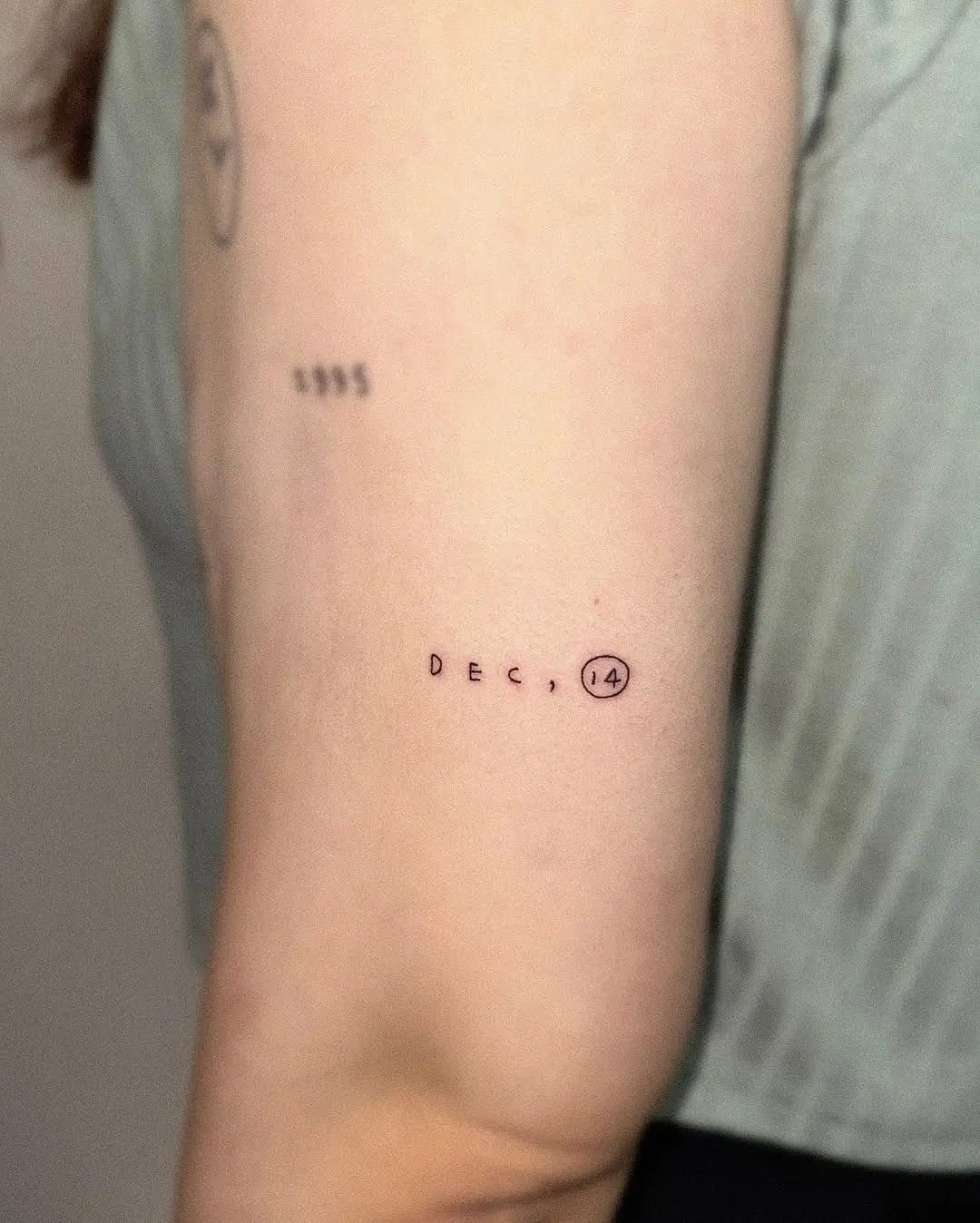 Minimalist Date Tattoo on Upper Arm
