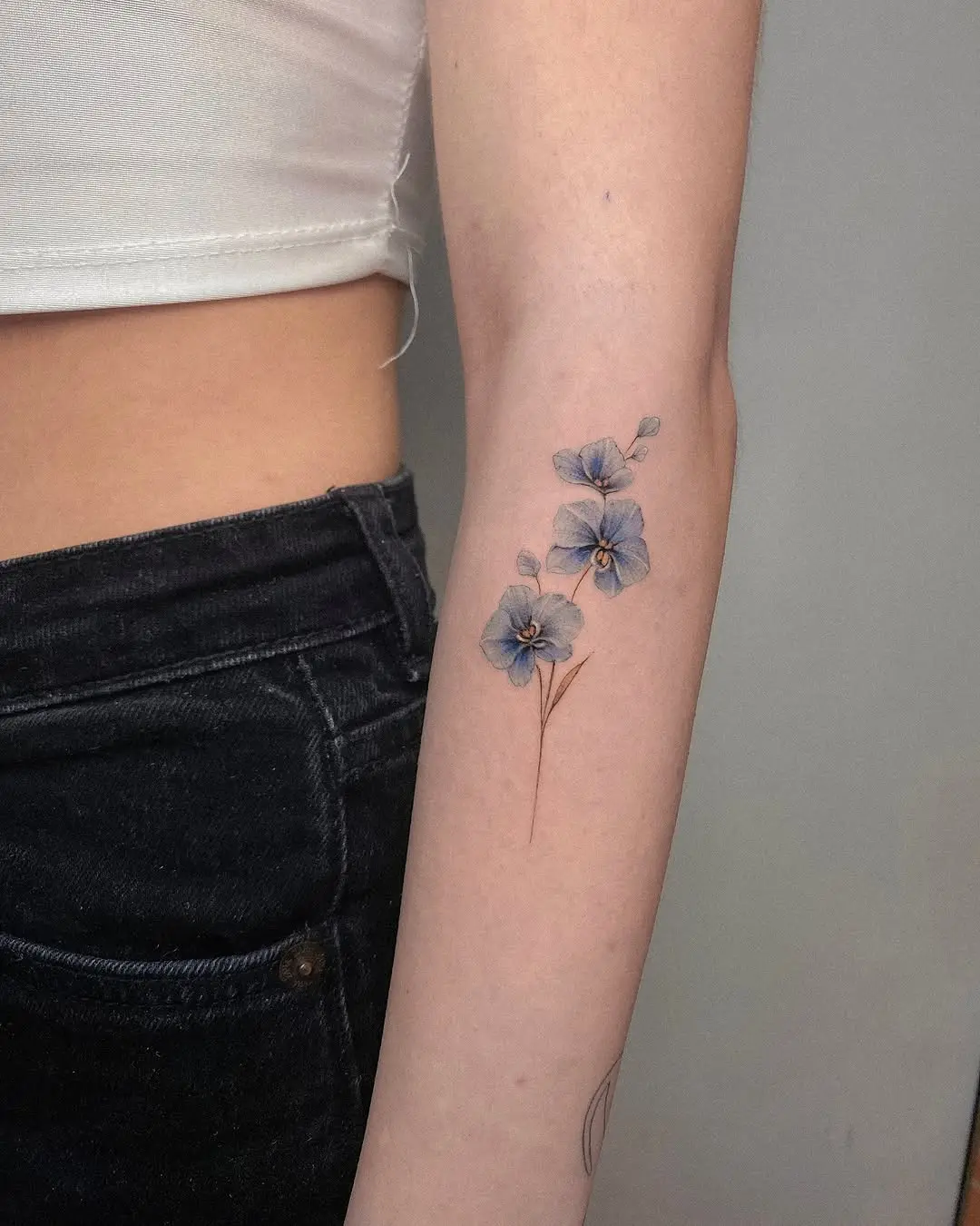 Elegant orchid tattoo design on the arm