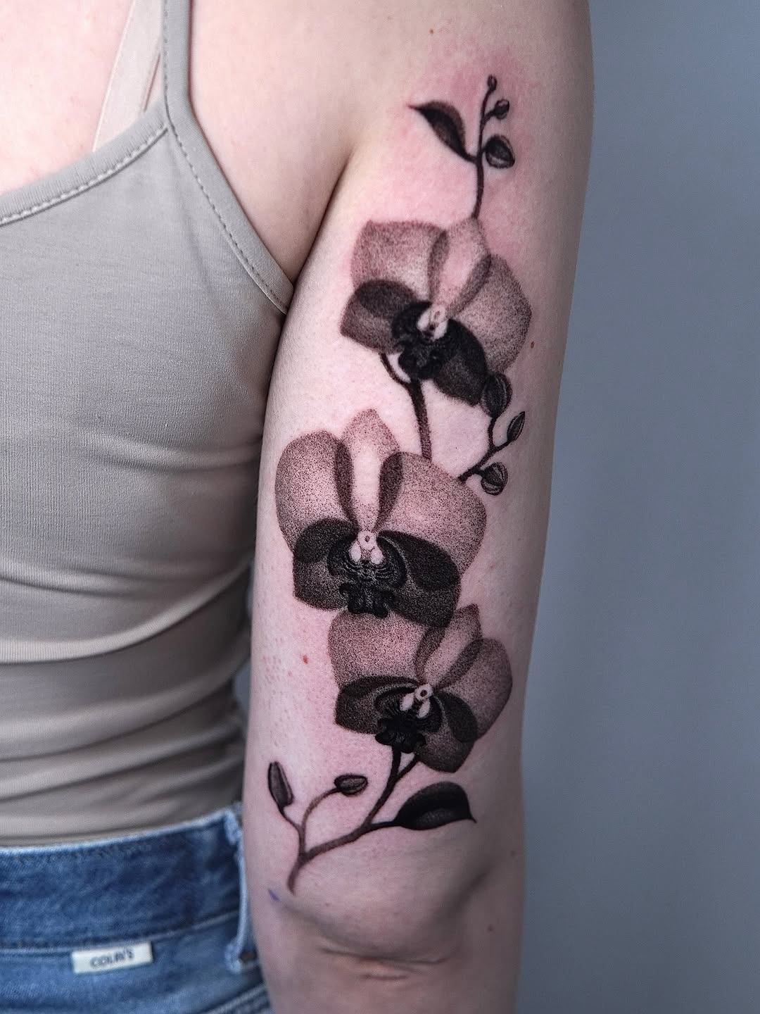 Stunning black and grey orchid arm tattoo
