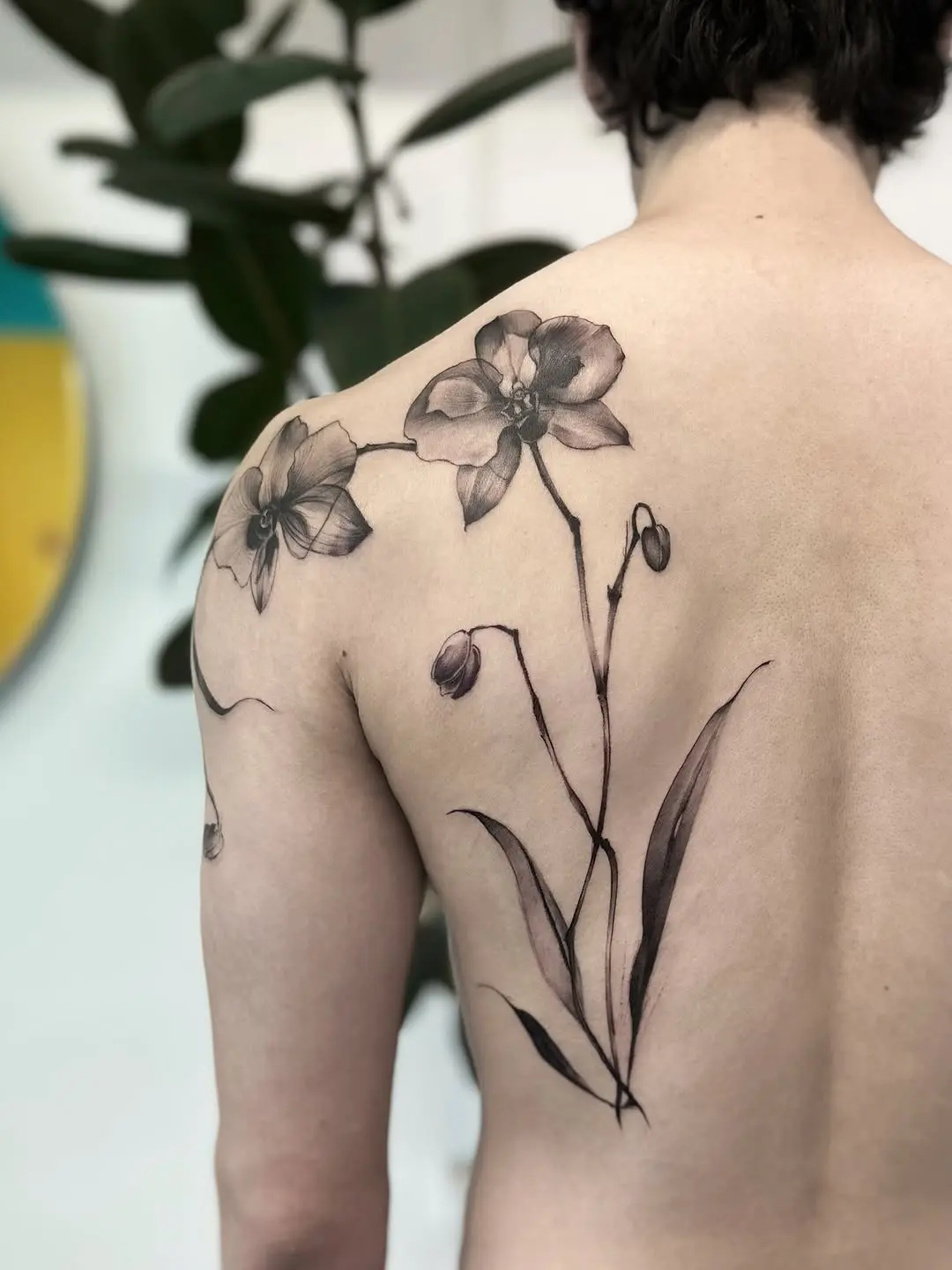 Elegant orchid tattoo on the back
