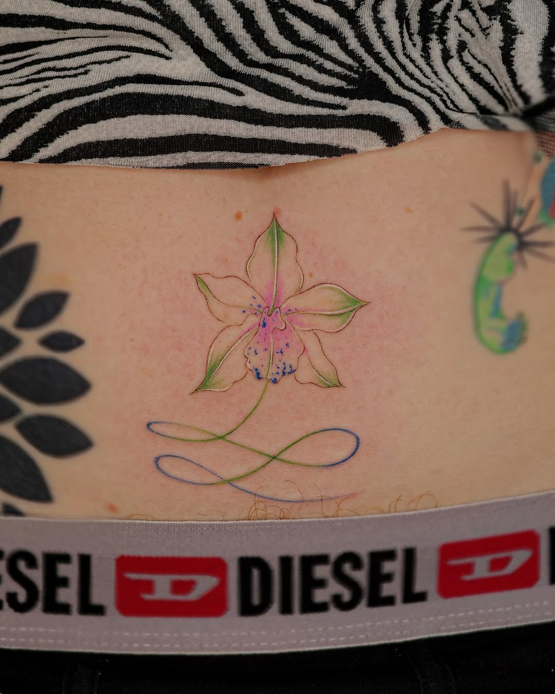Elegant orchid tattoo with delicate lines.