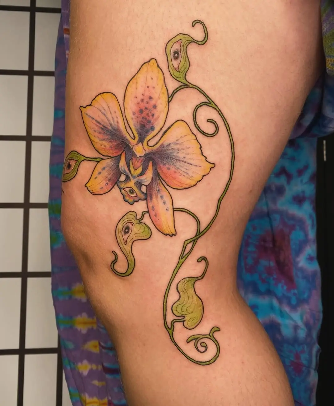 Elegant orchid tattoo design with vibrant colors