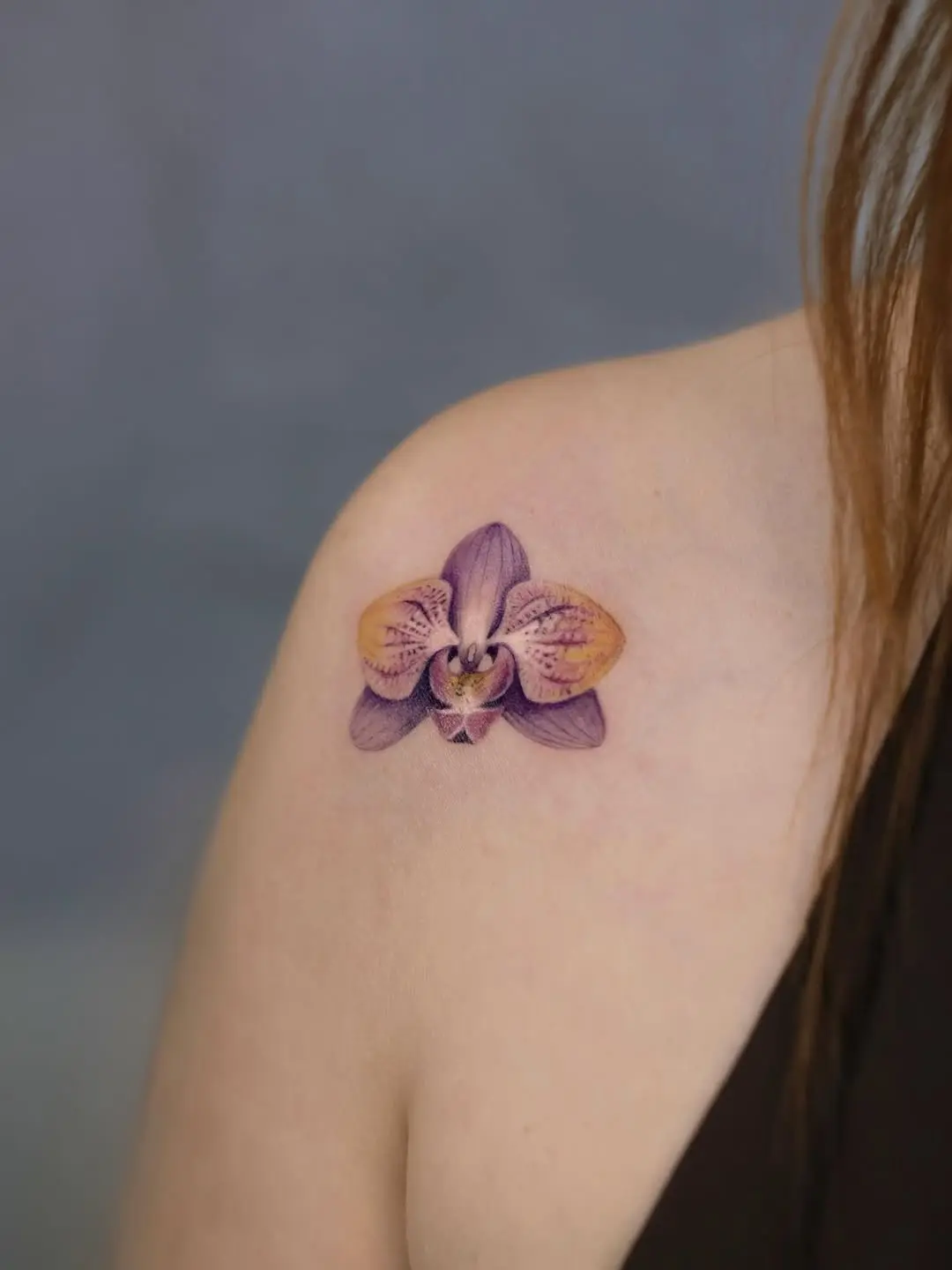 Stunning purple orchid tattoo on shoulder