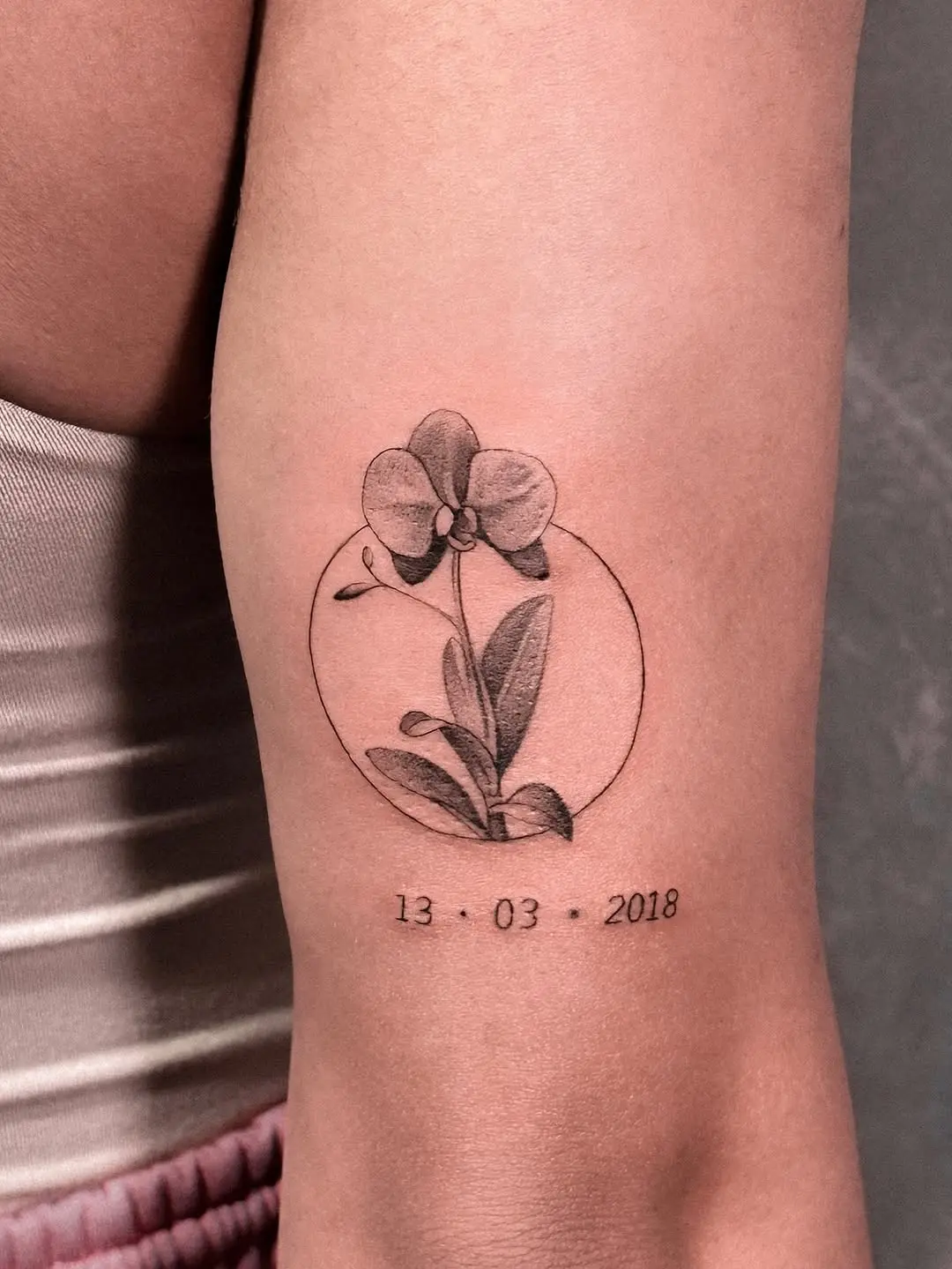 Elegant minimalistic orchid tattoo with date