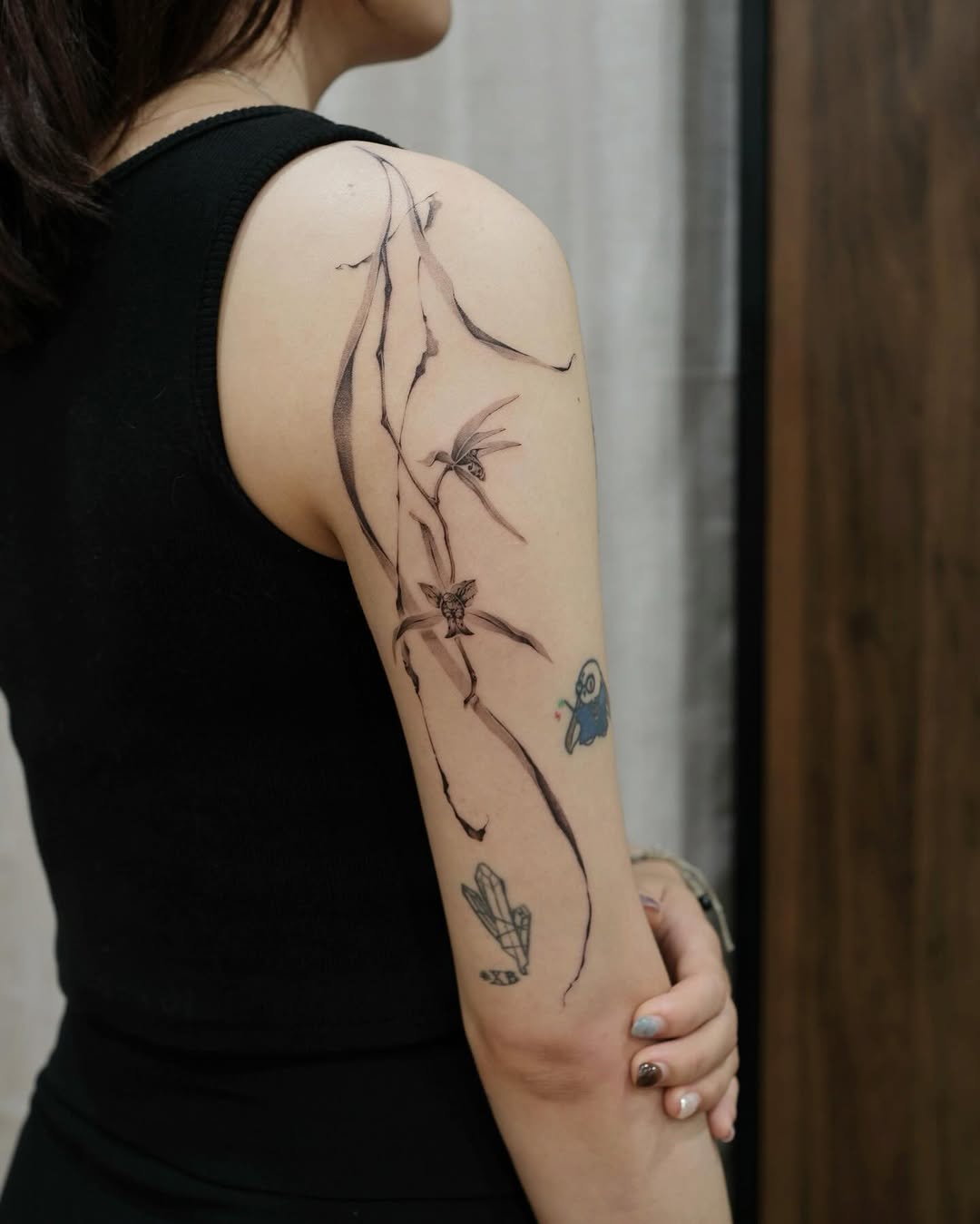 Artistic orchid tattoo on a woman's arm