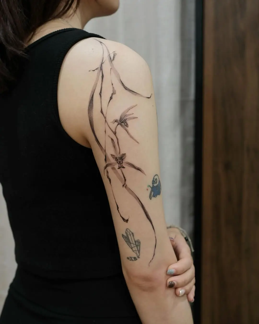 Artistic orchid tattoo on a woman's arm