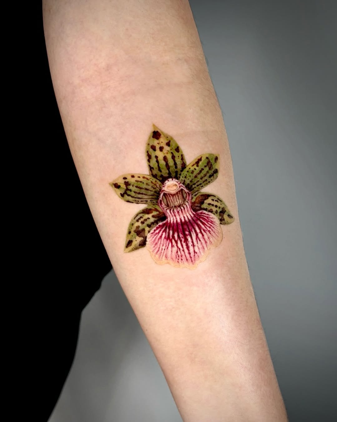Stunning orchid tattoo showcasing elegant floral artistry