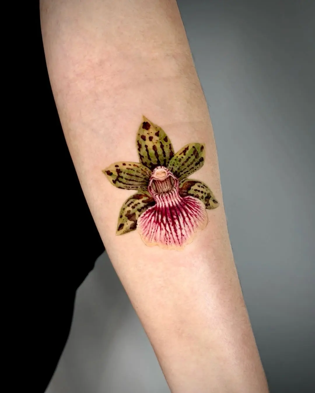 Stunning orchid tattoo showcasing elegant floral artistry