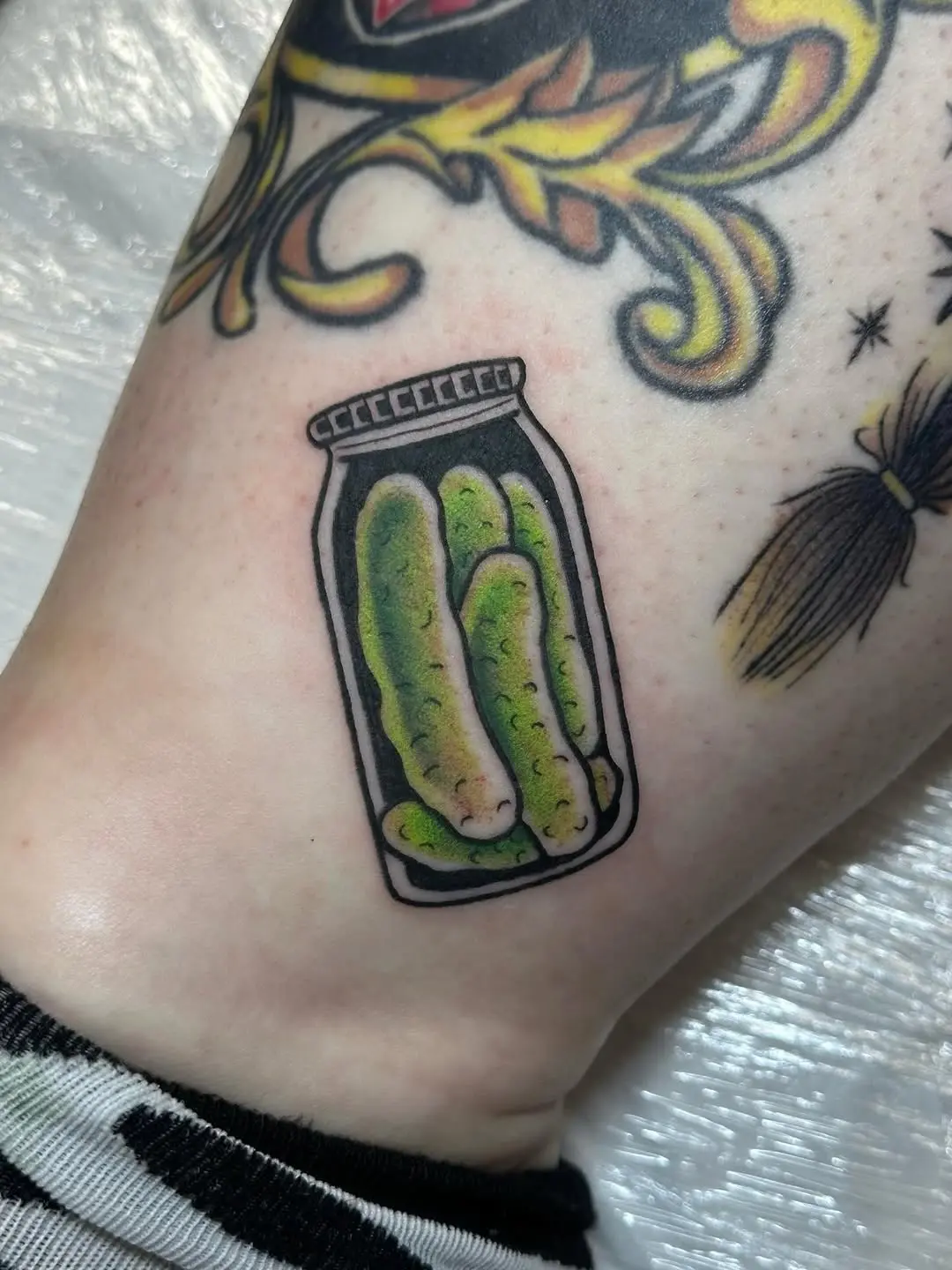 Whimsical pickles in a jar tattoo design
