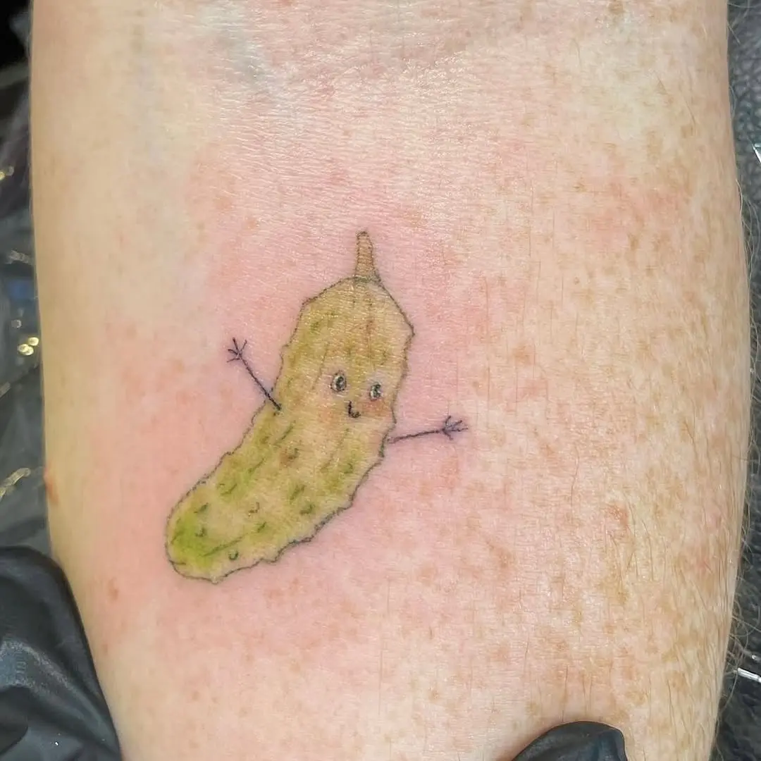 Adorable pickle tattoo with cheerful expression