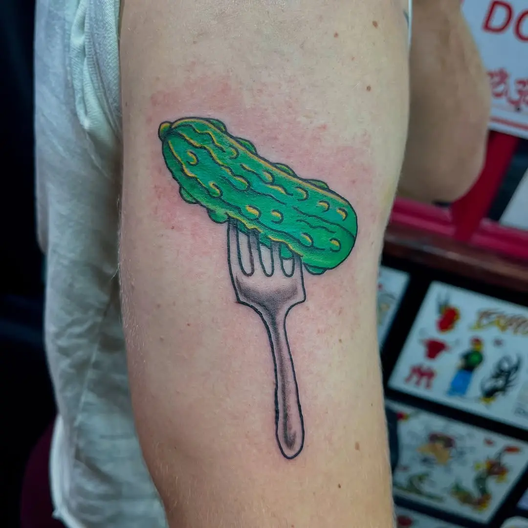 Playful pickle tattoo with a fork design