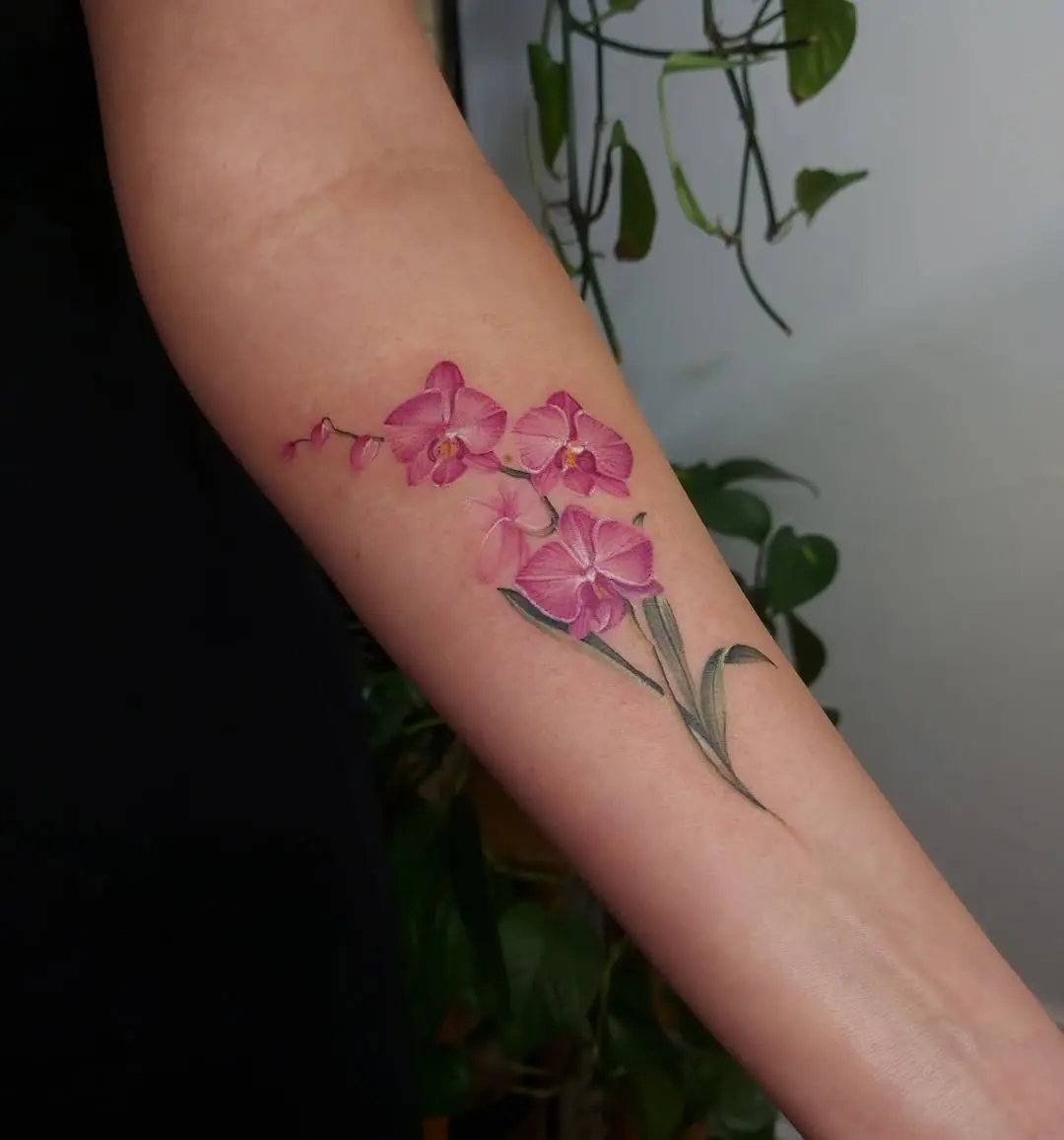 Stunning pink orchid tattoo on forearm