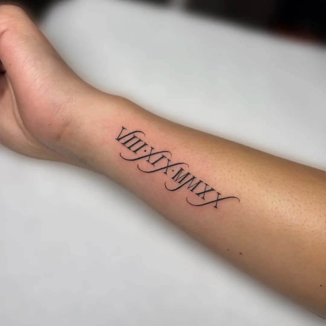 Elegant Roman Numerals on a Forearm