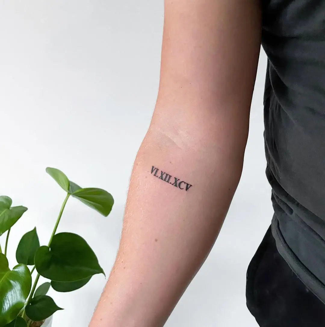 Stylish Roman numeral tattoo on forearm