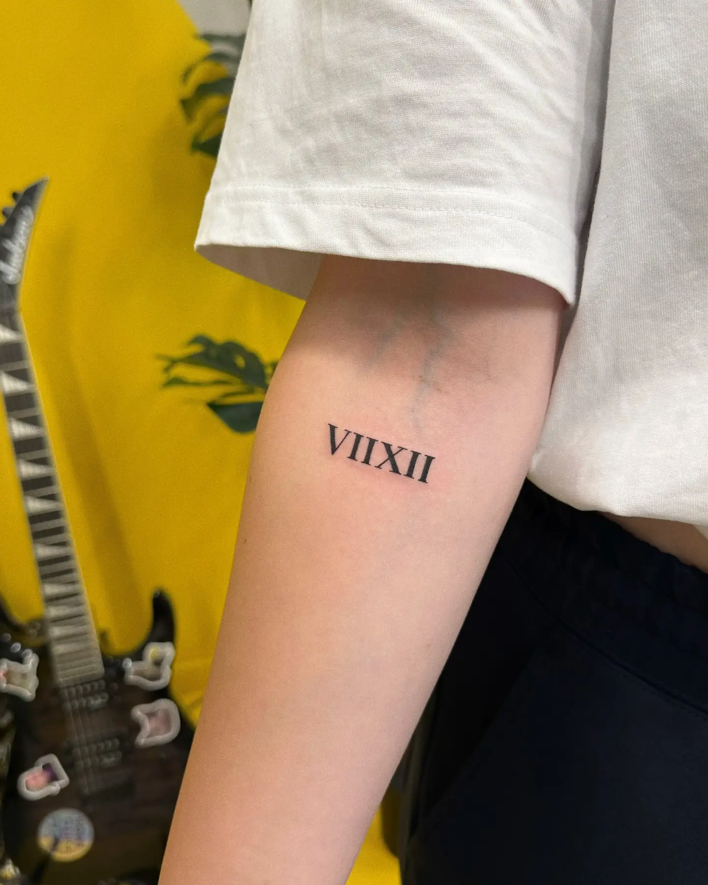 Stylish Roman numeral tattoo on the arm