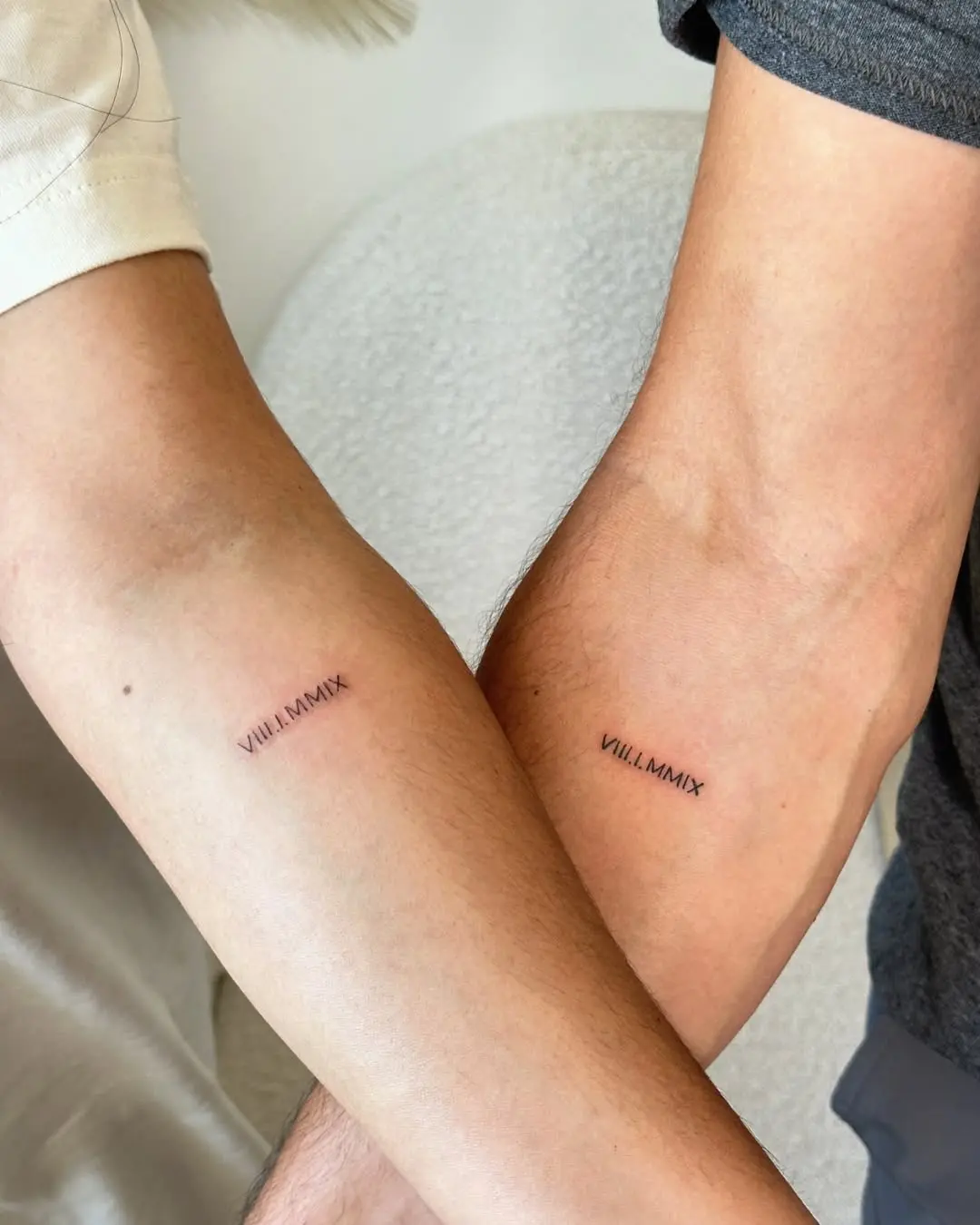 Couples' roman numeral tattoo showcasing unity