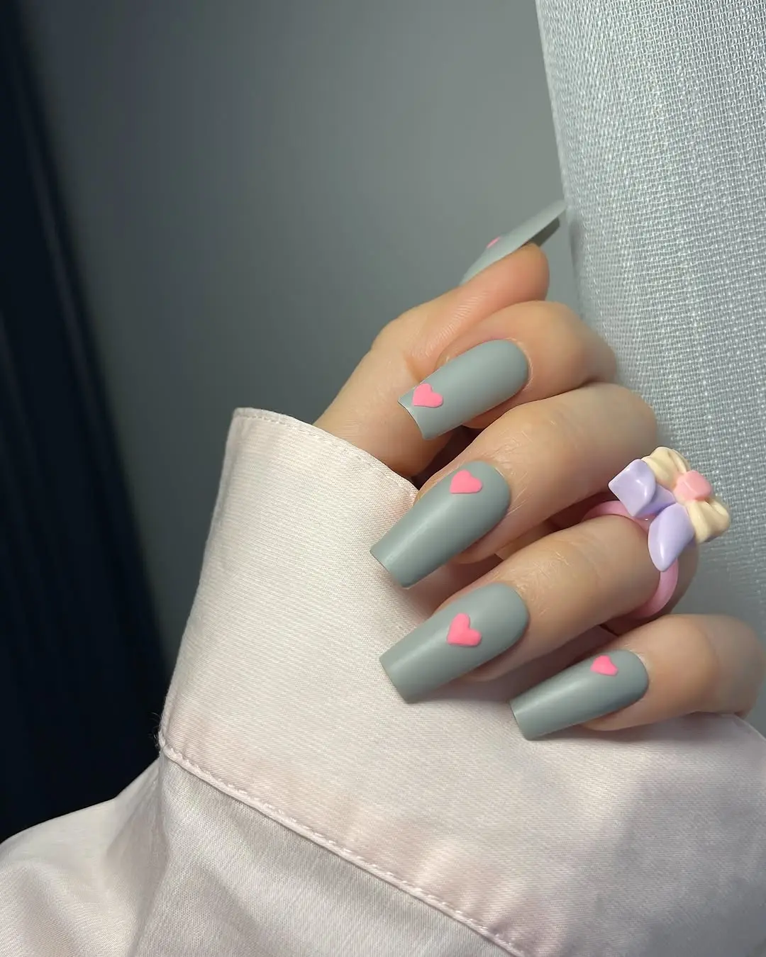 Chic matte nails with playful heart accents