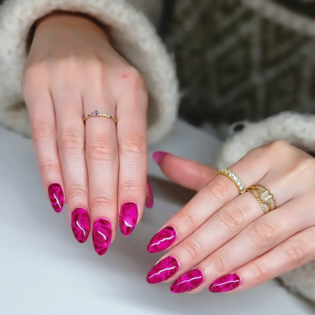 Bold pink marble-like nail design for romance