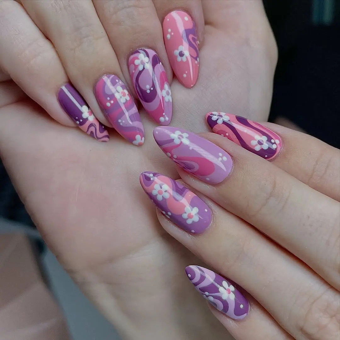 Charming floral patterns on playful purple nails