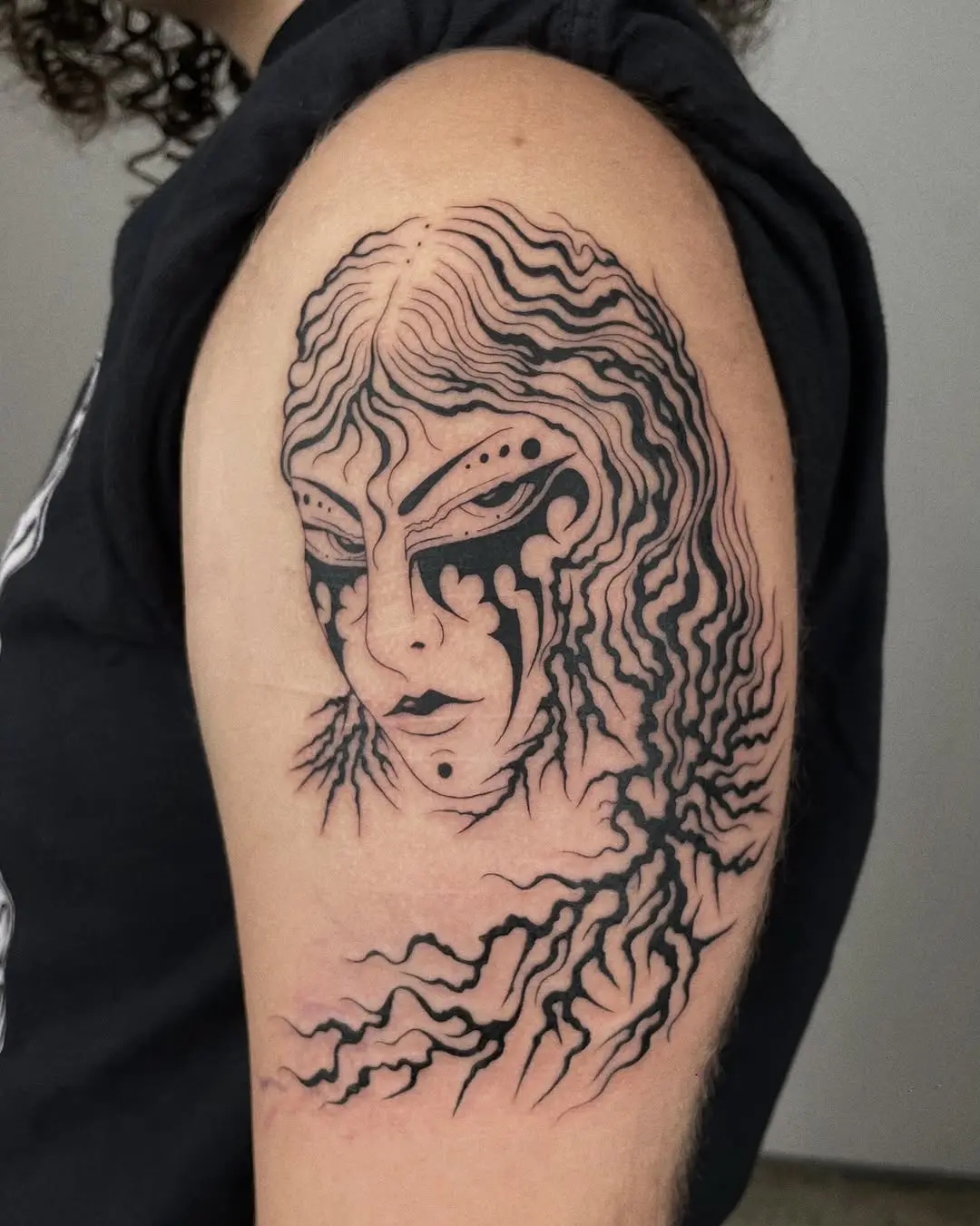 Intricate roots tattoo with enigmatic facial features