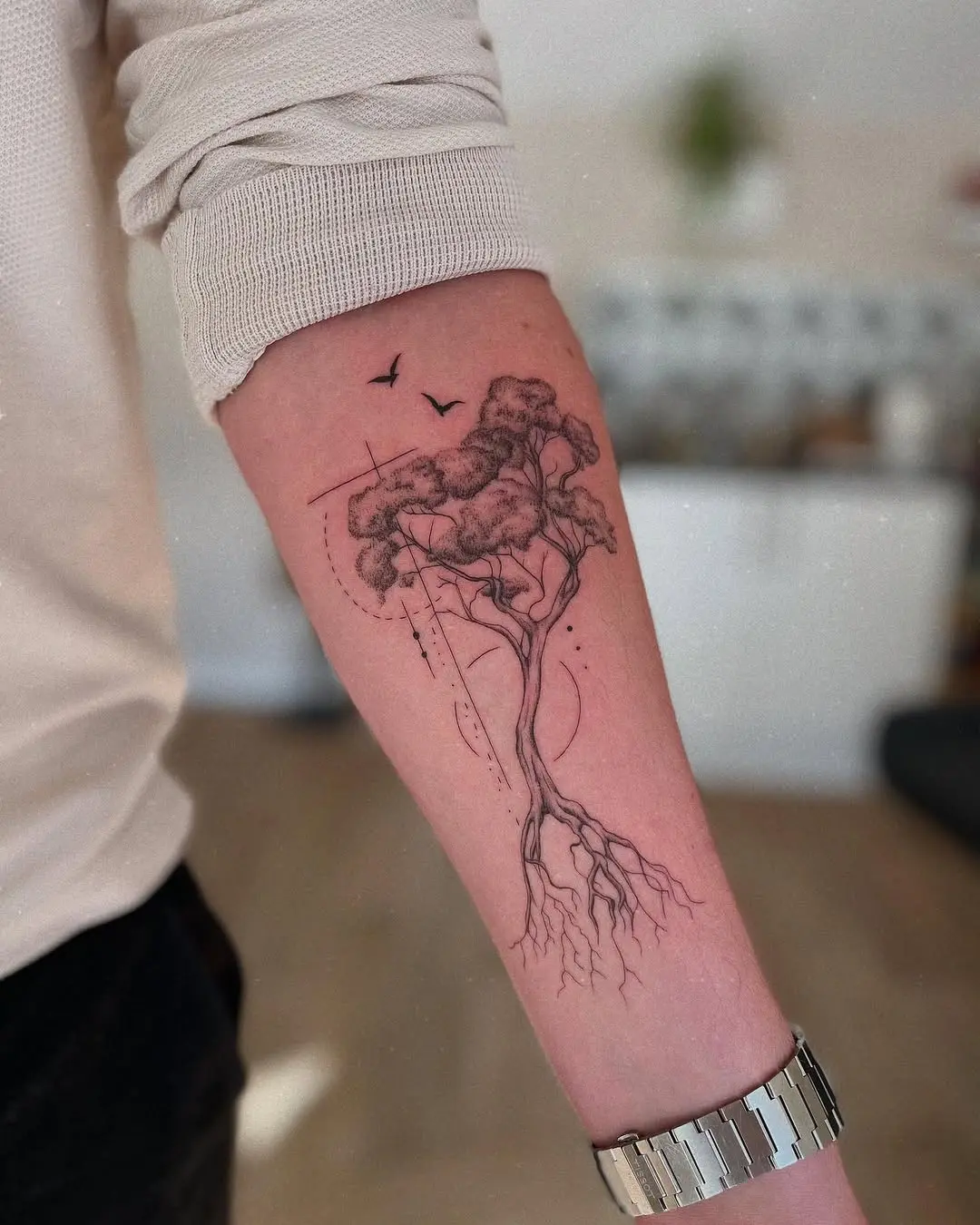 Elegant roots tattoo design on forearm