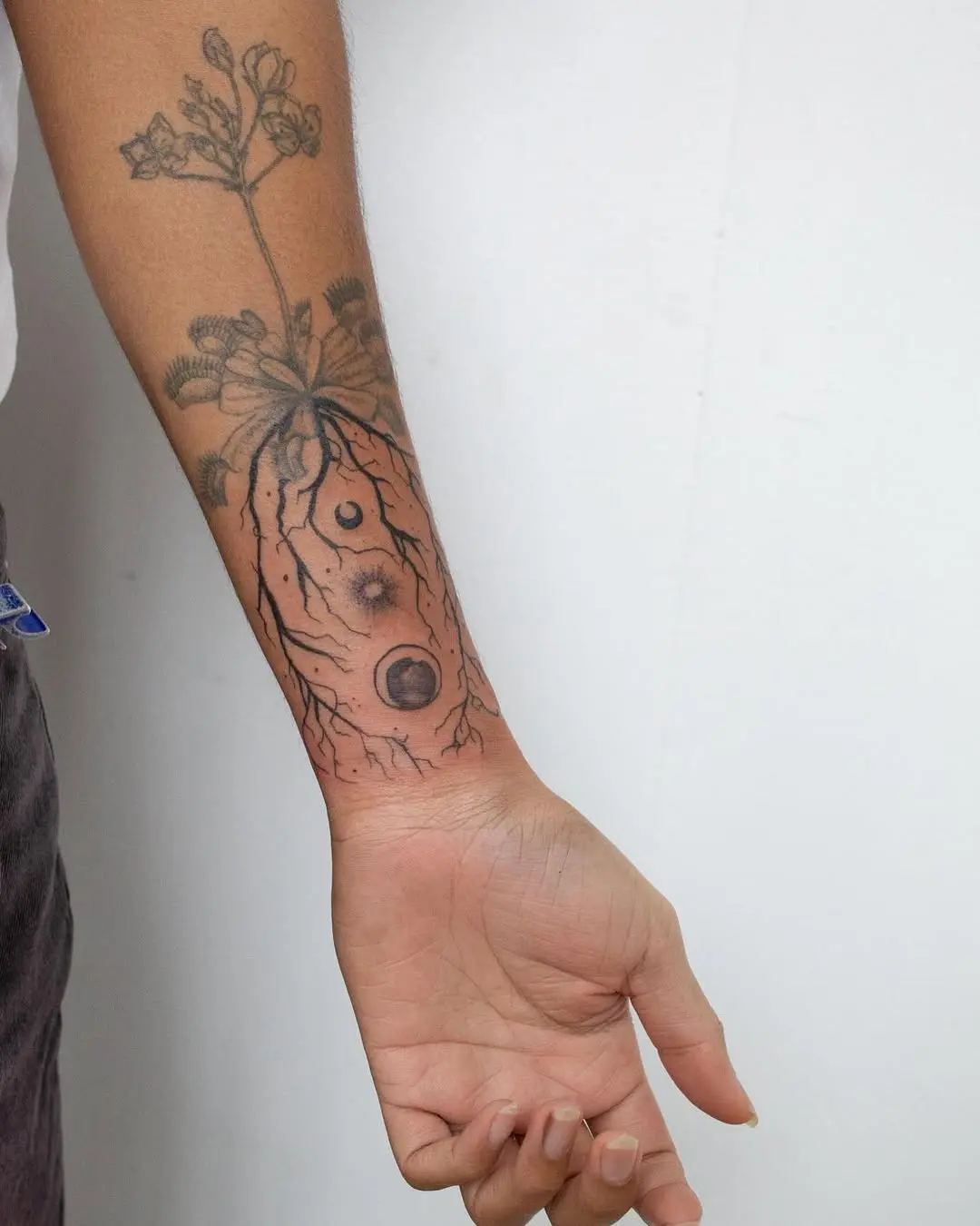 Intricate roots tattoo embracing nature's essence