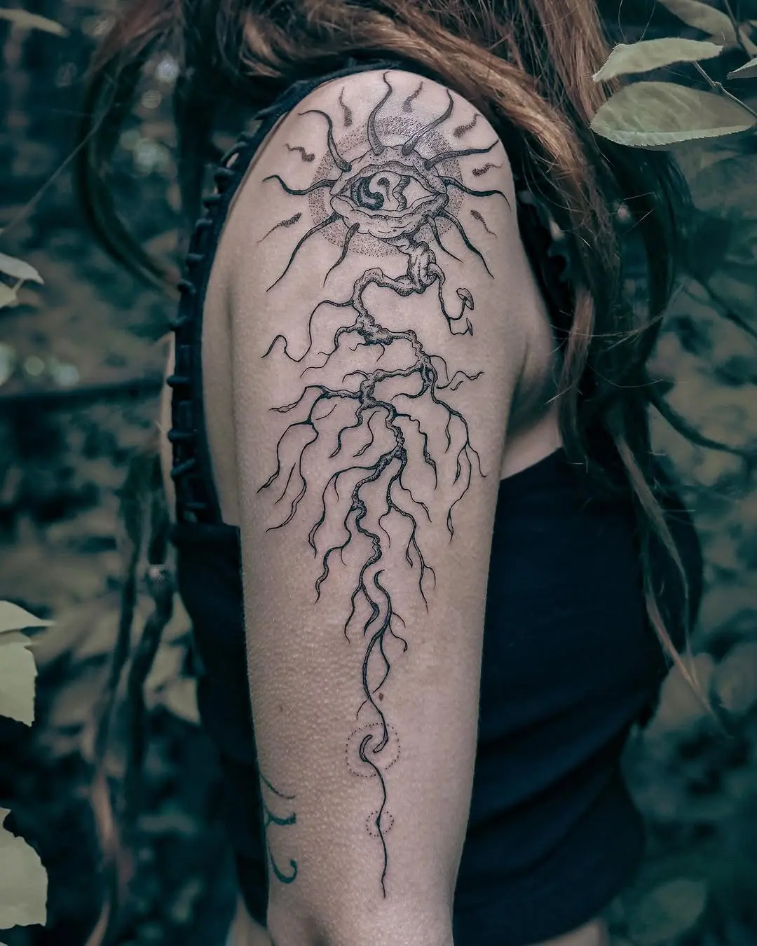 Stunning roots tattoo with a sun motif