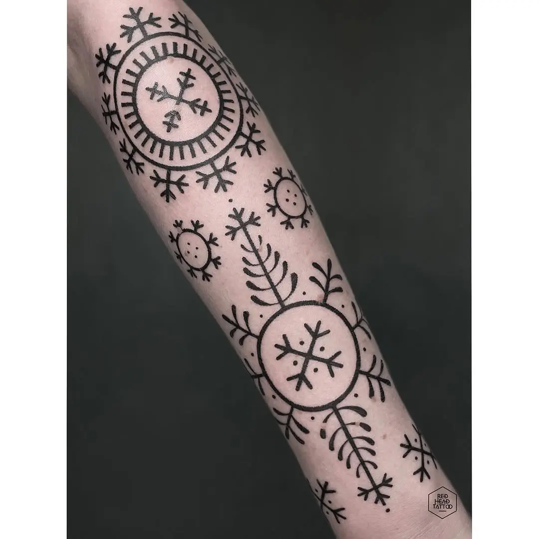 Intricate geometric roots tattoo design on forearm