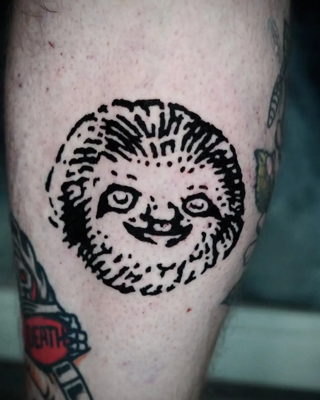 Cute sloth tattoo bursting with charm