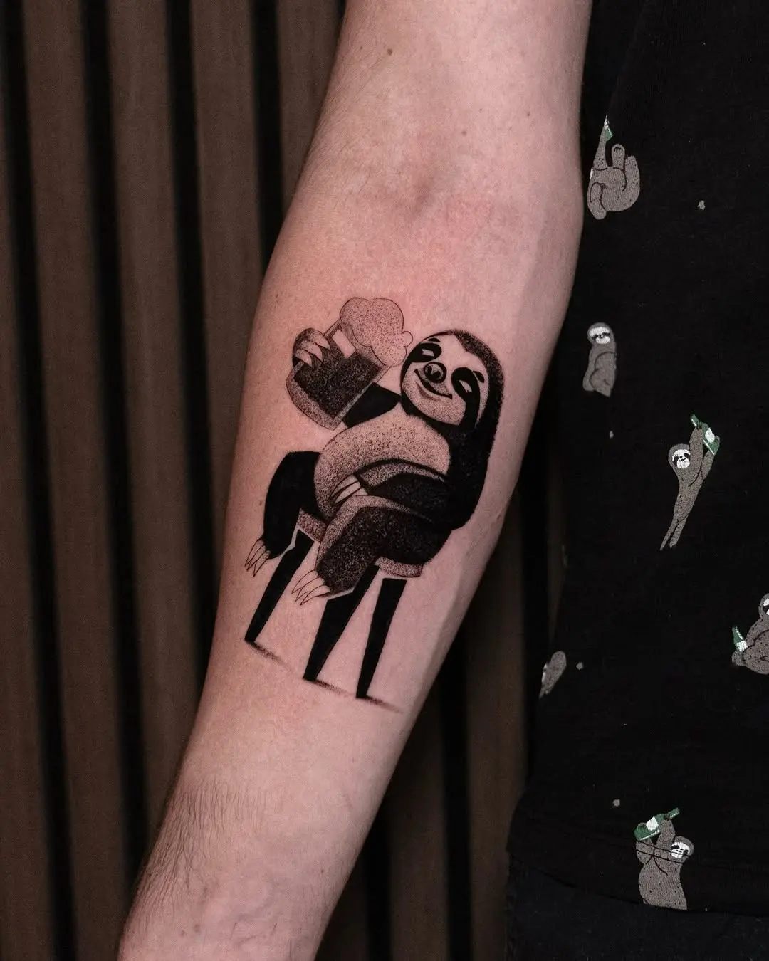 Whimsical sloth enjoying a drink tattoo