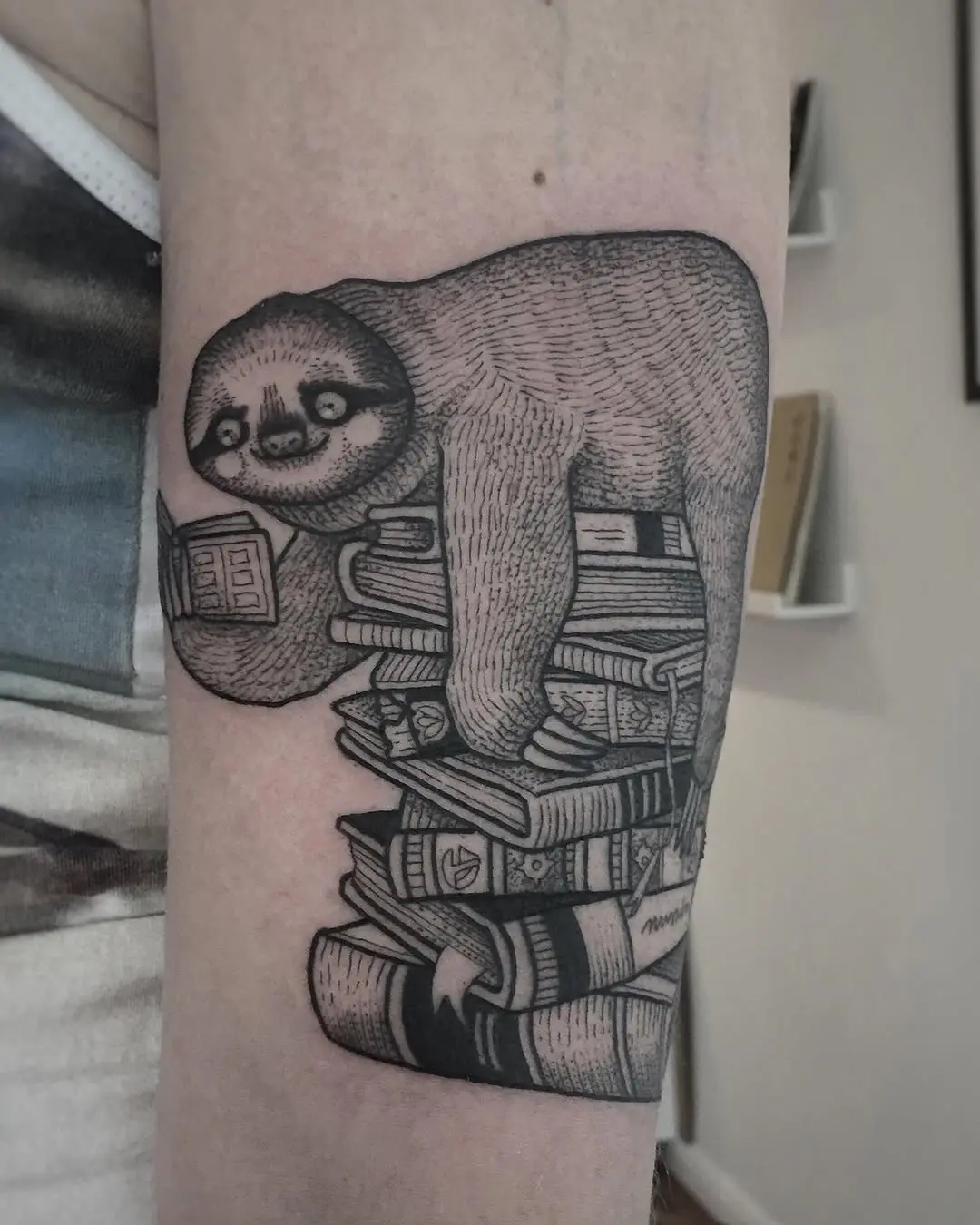 Charming sloth balancing on a book stack