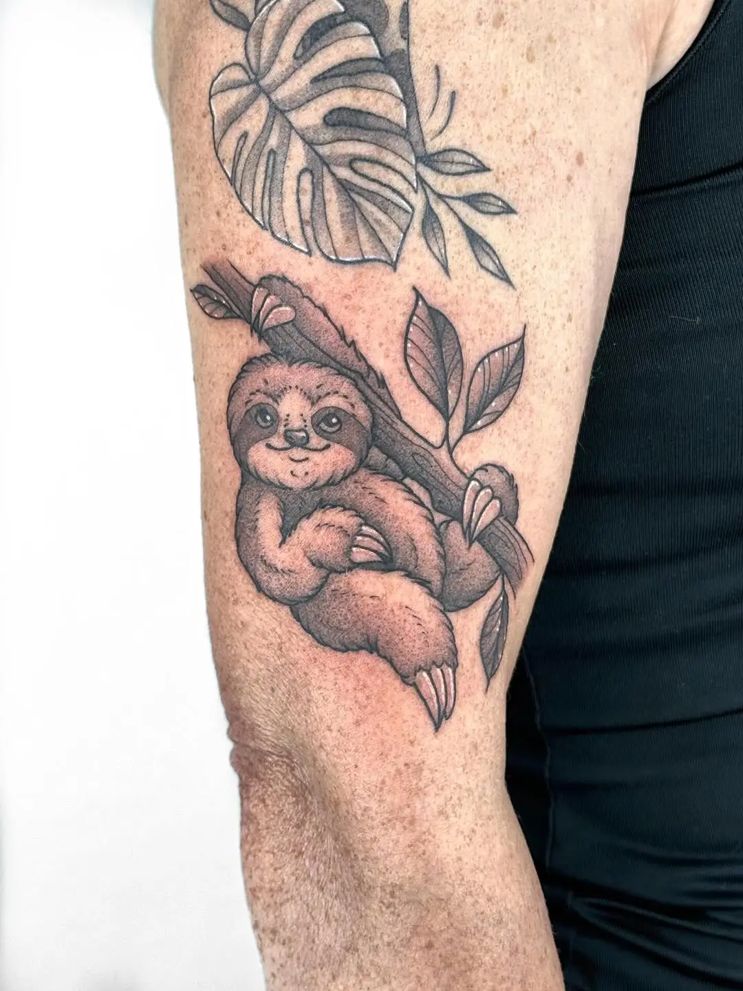 Charming Sloth Tattoo Hanging from Branch