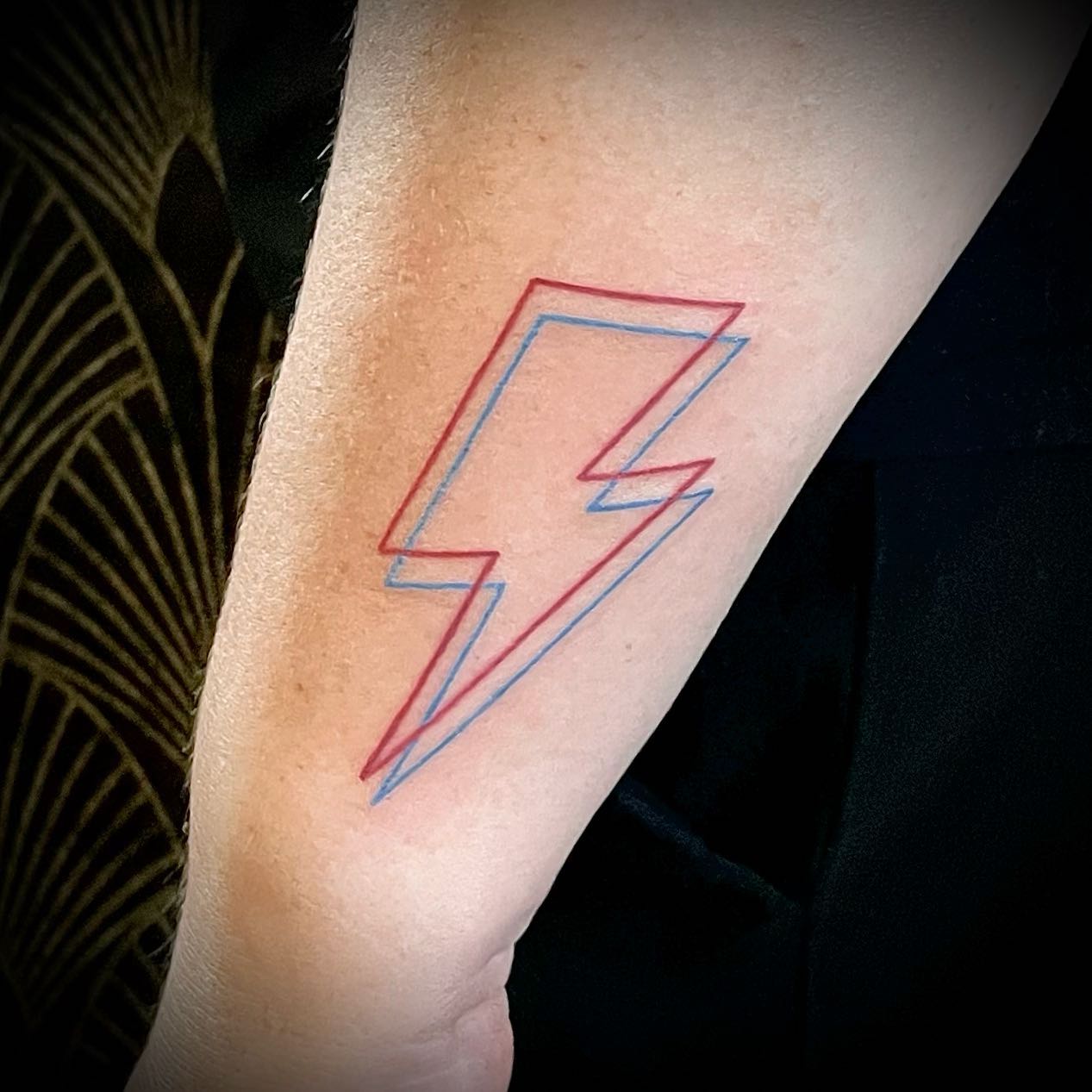 Colorful and modern lightning bolt tattoo design