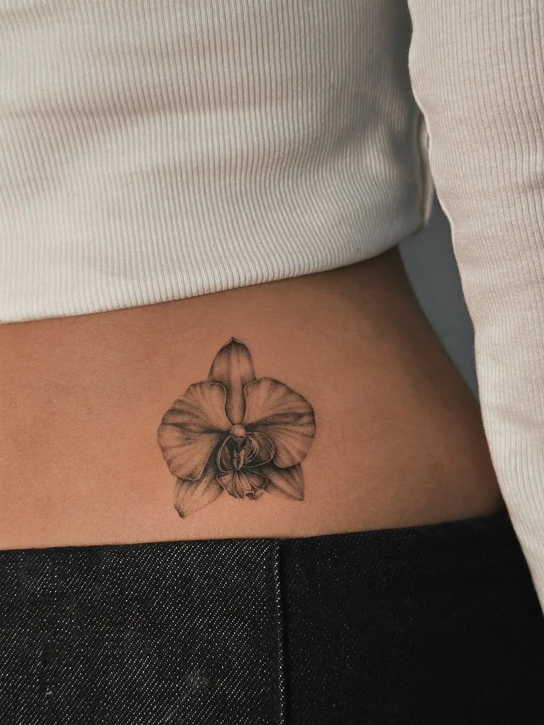 Elegant black and white orchid tattoo design