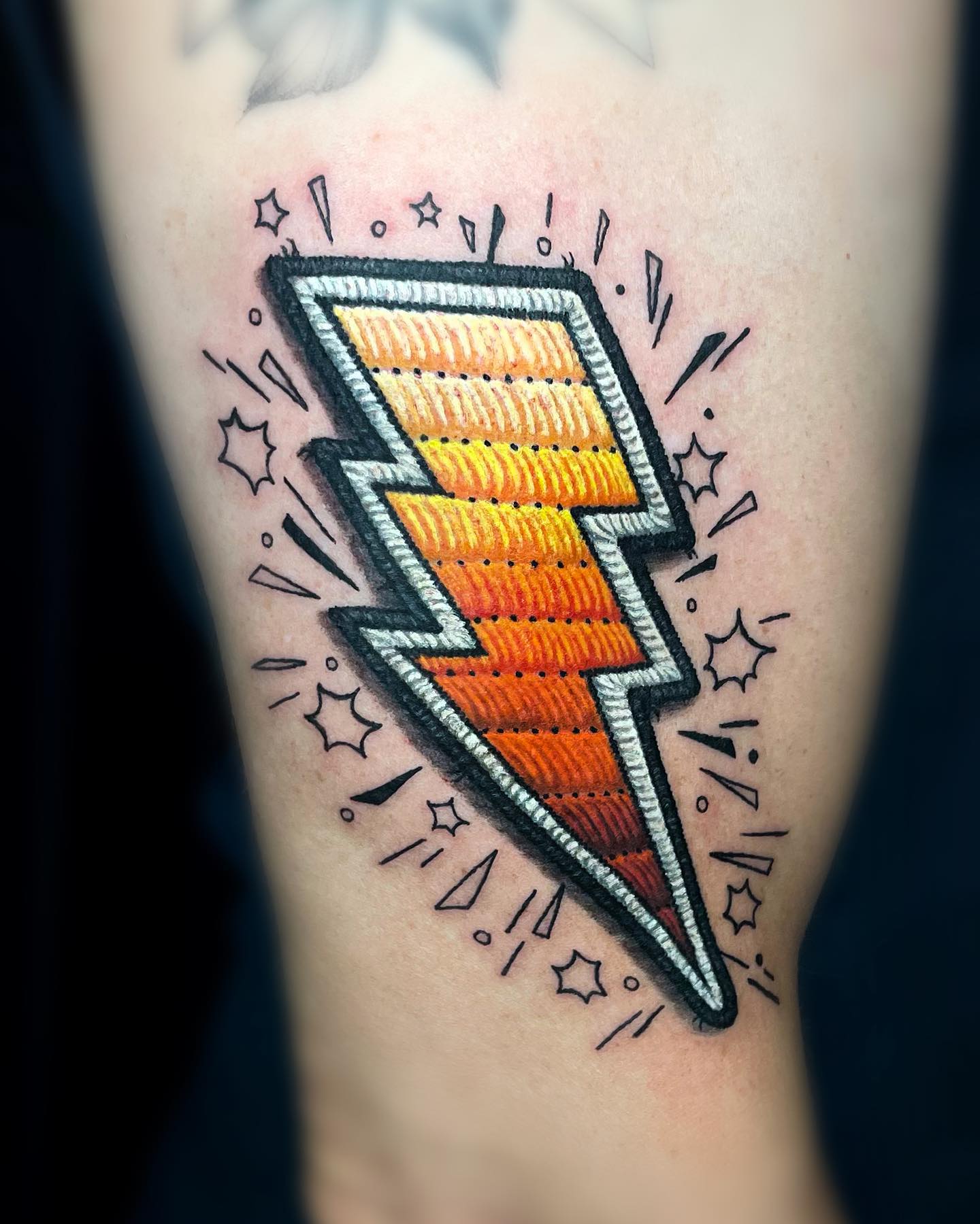 Dynamic lightning bolt tattoo with vibrant colors