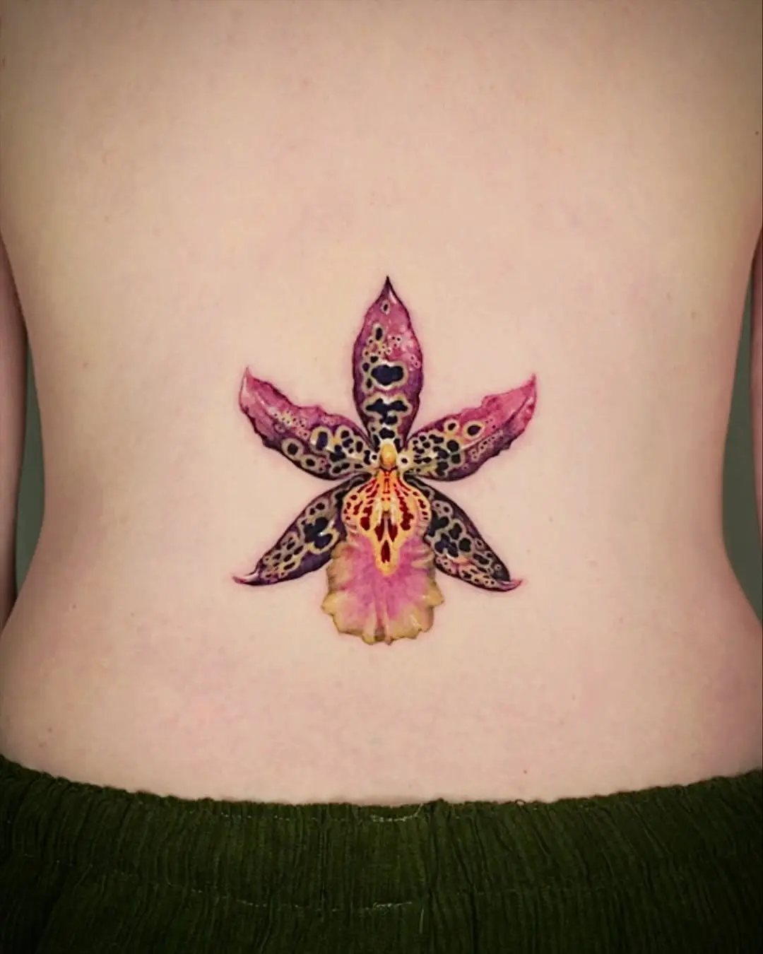 Stunning watercolor orchid tattoo design on back