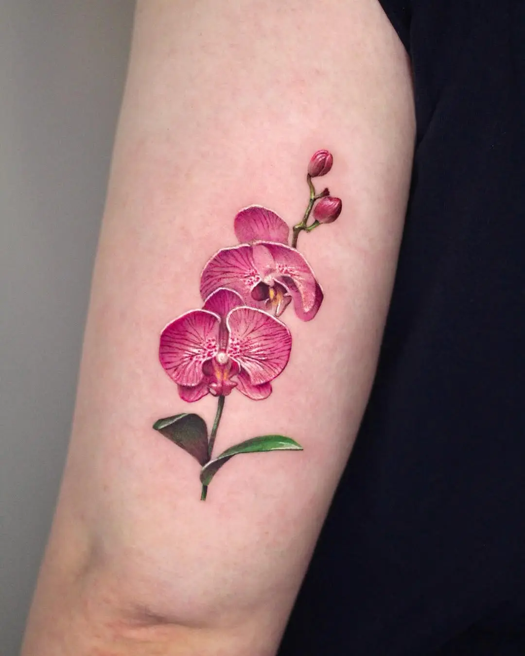 Stunning vibrant orchid tattoo in bloom
