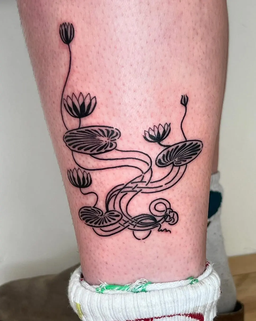 Elegant Art Deco-Inspired Lily Pad Tattoo