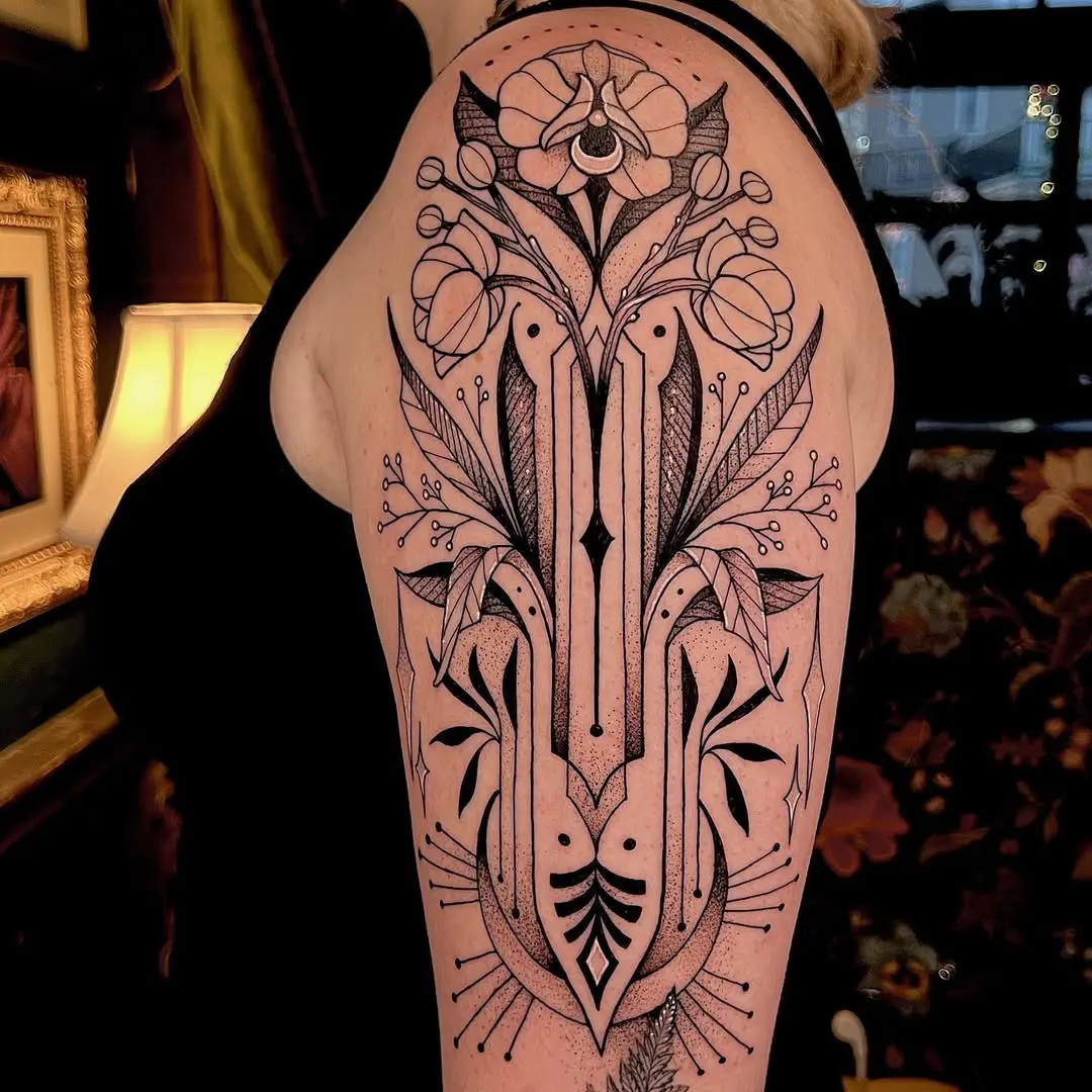 Elegant black ink art deco floral tattoo