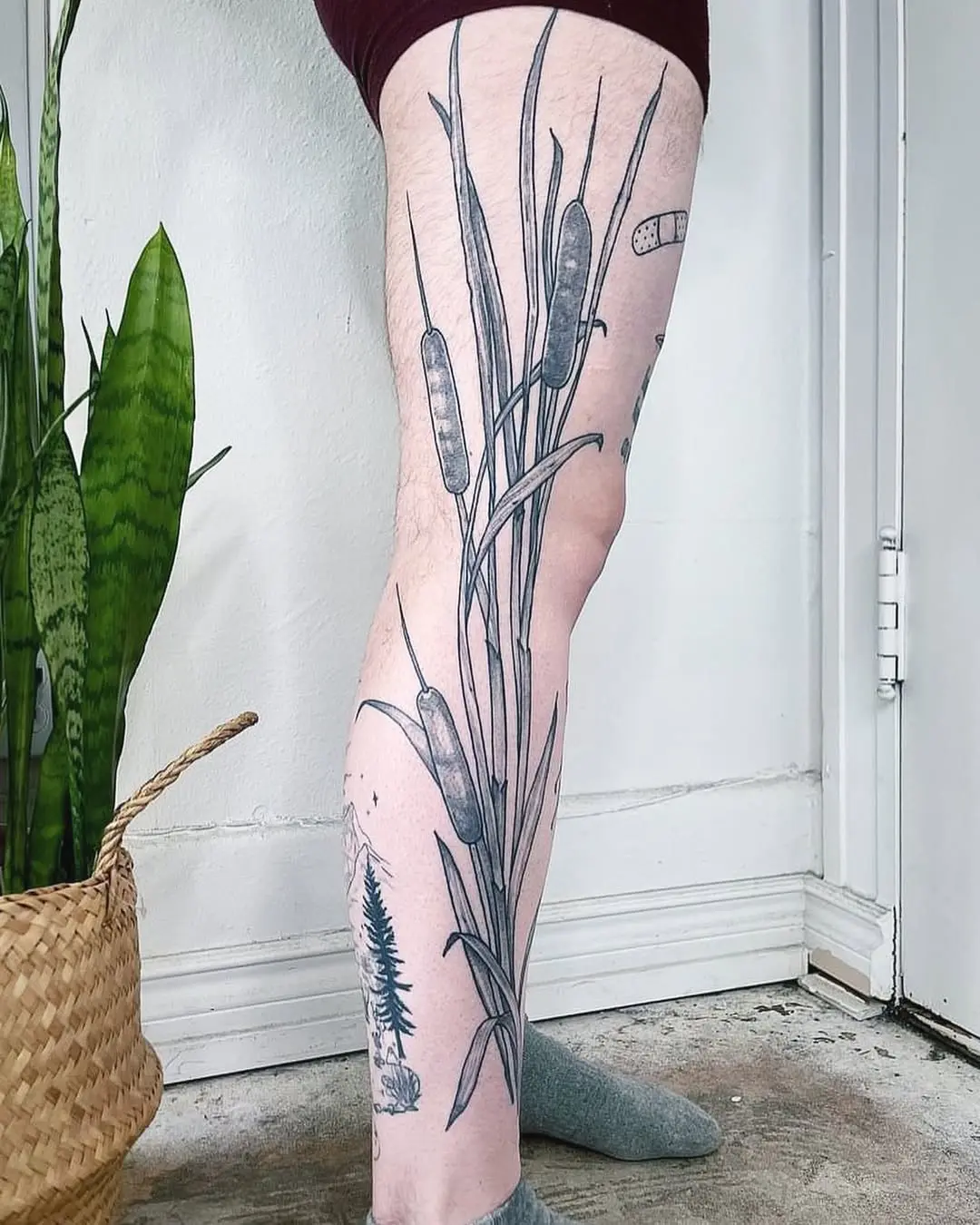 Elegant cattail tattoo showcasing nature's beauty