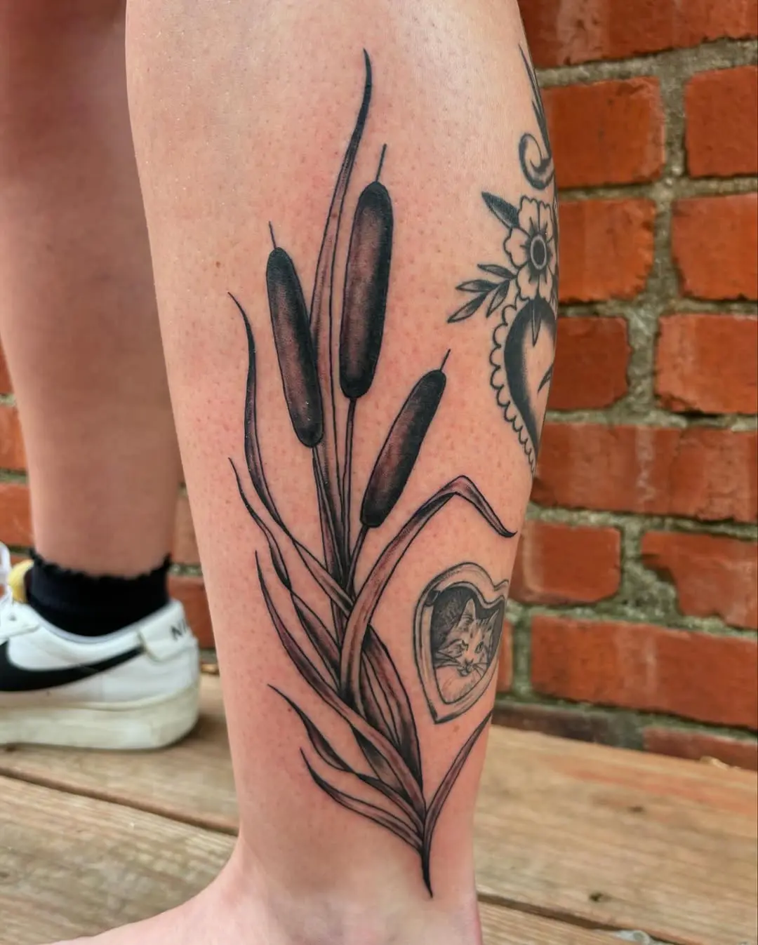 Elegant cattail tattoo with heart motif