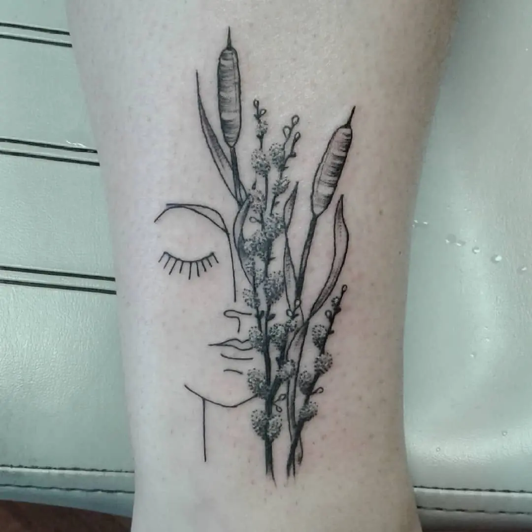 Elegant cattail tattoo with abstract face design